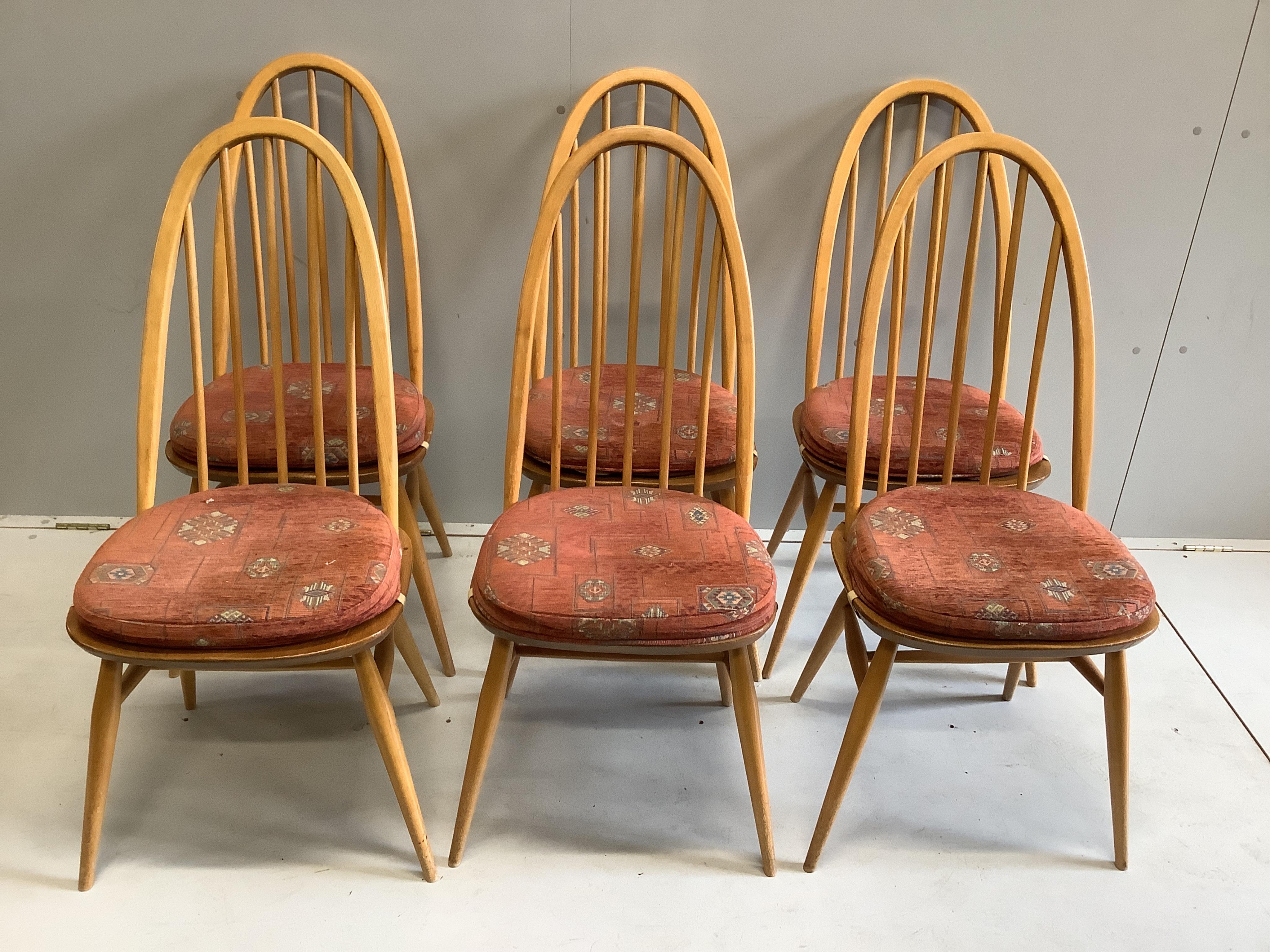An Ercol rectangular elm dining table, width 150cm, depth 75cm, height 71cm together with six Ercol comb back dining chairs